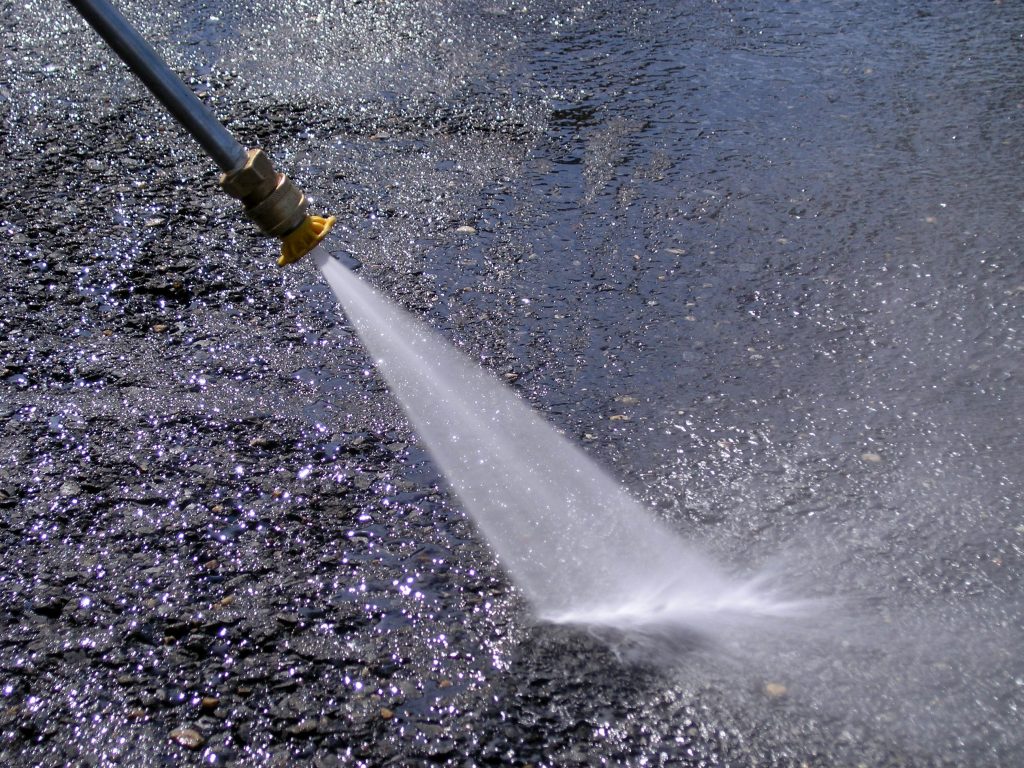 Cleaning with a pressure washer.
